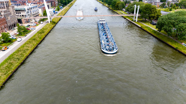 Large inland ship at Dutch Amsterdam Rijn canal sailing near city Utrecht,  drone shot
