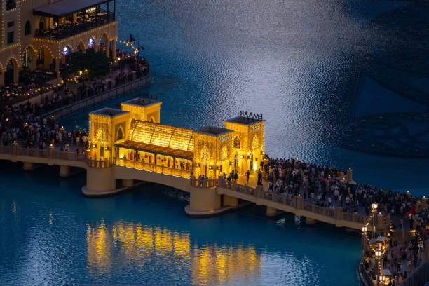 Souk Al Bahar Bridge at the Dubai Mall and Fountain, seen at night in Dubai, United Arab Emirates.