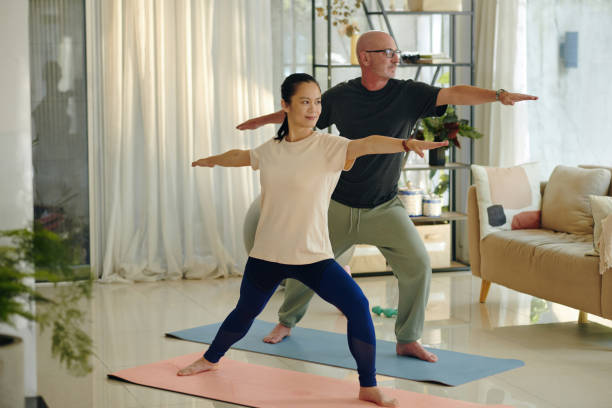 istock Practicing Yoga Poses in Comfortable Living Room 2168760245