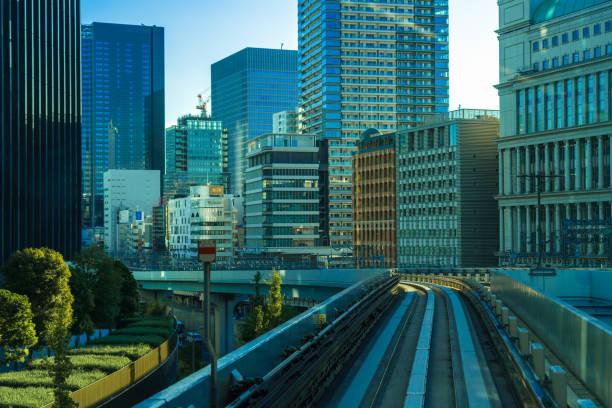 Tokyo, Japan- October 13, 2023:This captivating image captures the essence of modern urban life, showcasing the harmonious blend of transportation infrastructure and architectural marvels. The tracks of the metro snake through the cityscape, while the towering skyscrapers reach for the sky, creating a dynamic interplay of lines and shapes. This photograph is a testament to the ingenuity of urban planning and the beauty of human-made structures coexisting with the natural flow of city life. Perfect for those who appreciate the fusion of technology and art in metropolitan settings.