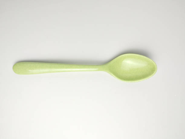 istock Green melamine spoon isolated on white background 2168766976