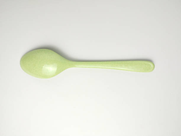 istock Green melamine spoon isolated on white background 2168767041