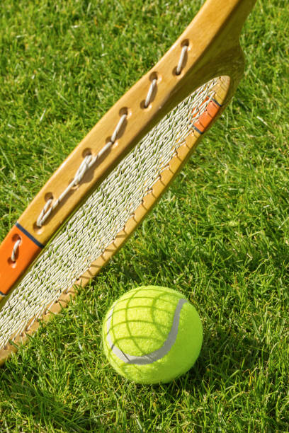 istock Racket and tennis ball on green grass. 2168768727