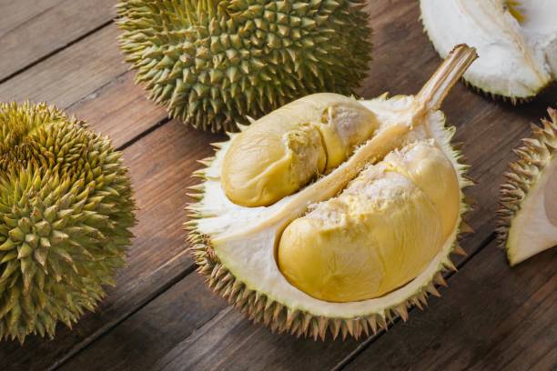 istock Durian fruit cut in half on a wooden table. 2168771371