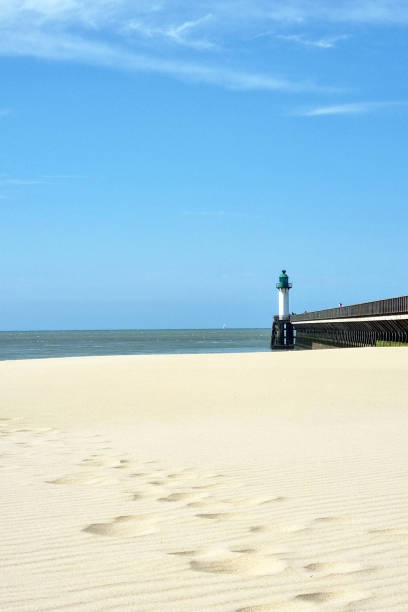 istock Serene Beach with Lighthouse and Pier - Tranquil Coastal Landscape for Print, Posters, or Wall Art 2168772565