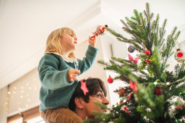 istock Family decorating Christmas tree at home 2168774939
