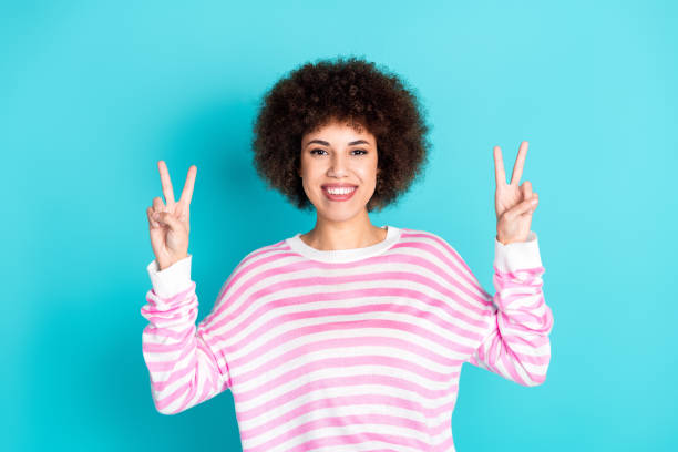 istock Photo of cheerful pretty lady dressed pink pullover showing two v-signs empty space isolated teal color background 2168776427