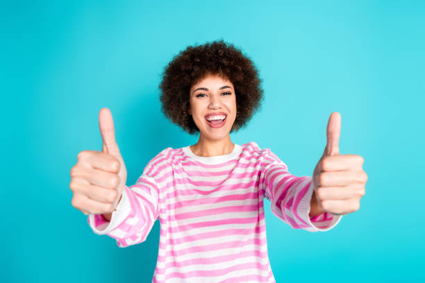 istock Photo of shiny attractive lady dressed pink pullover showing two thumbs up empty space isolated turquoise color background 2168776432