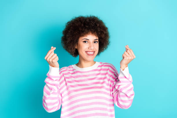 istock Photo of cheerful pretty lady dressed pink pullover showing two korean heart gestures empty space isolated teal color background 2168776540