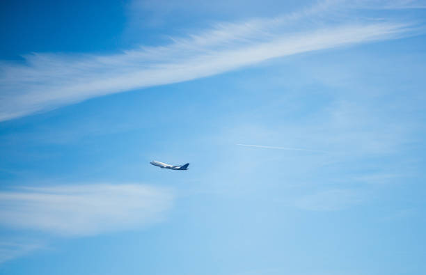 Airplane flying in the distance in the blue sky above Frankfurt am Main