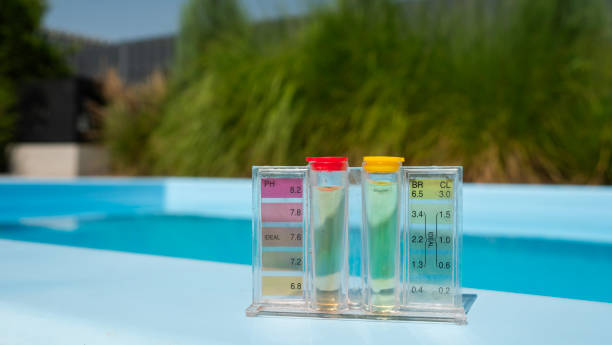 istock A pool water testing kit showing pH and chlorine levels is placed on the pool's edge, with a blurred green background. 2168778389