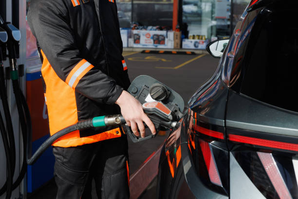 istock Hand holding gas nozzle and hose and refueling 2168779625