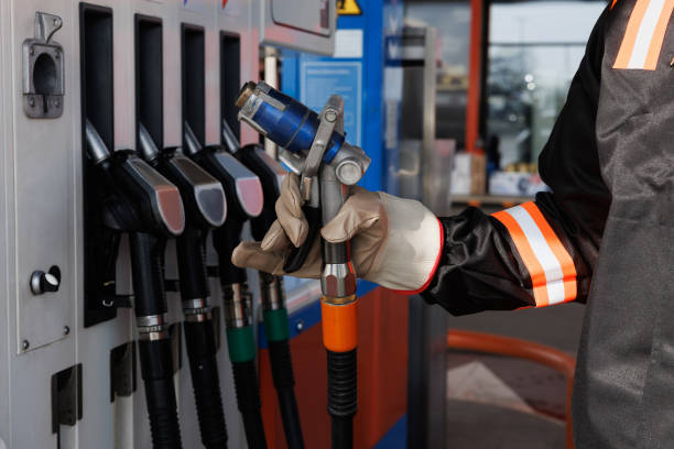 istock Hand in protective glove holding LPG (liquefied petroleum gas) nozzle at fuel pump 2168779637