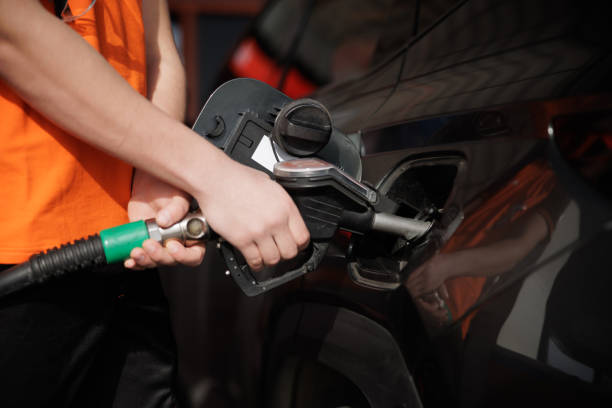 istock Hand holding gas nozzle and hose and refueling 2168779662