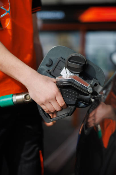 istock Hand holding gas nozzle and hose and refueling 2168779691