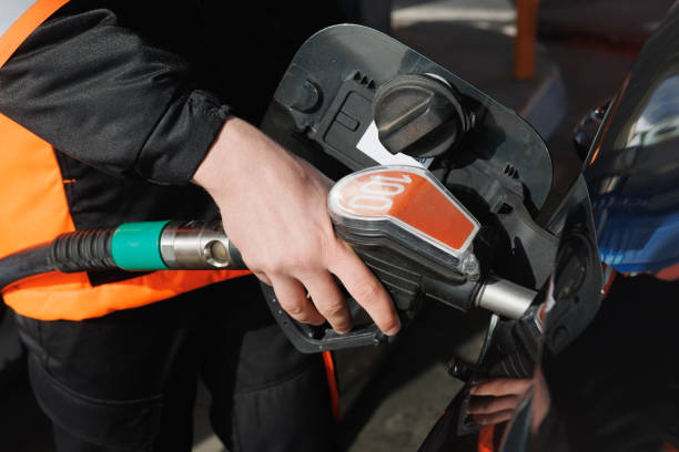 istock Hand holding gas nozzle and hose and refueling 2168779709