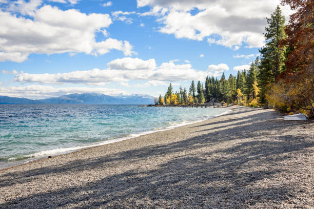 Deserted pebble beach on a mountain lake on a sunny autumn day. Autumn colours. Lake Tahoe, CA, USA.