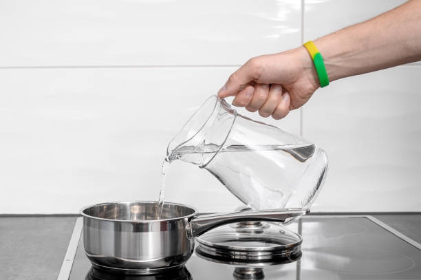 istock Pour water from the jug into the pot, boiled water 2168794972