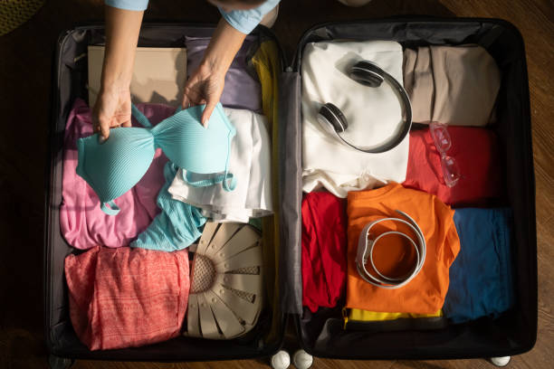 istock Woman organizing clothes and packing suitcase for trip 2168797049