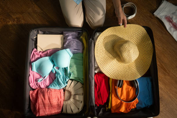 istock Woman organizing clothes and accessories inside suitcase 2168798022