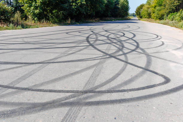 skid marks on a road surface. Circular tire marks left by drivers doing doughnuts