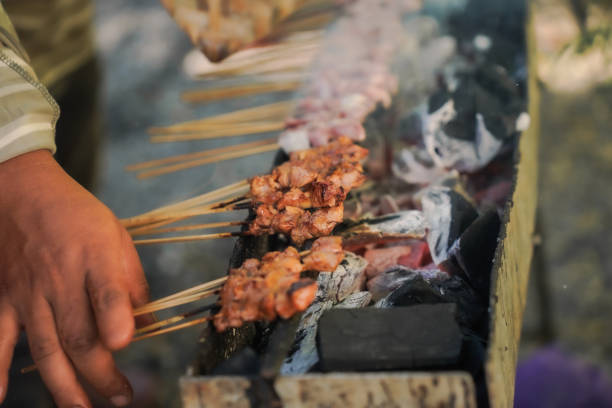 istock sate kambing or satay goat, lamb, Lamb or meat goat satay with charcoal ingredient on red fire grilling by people. traditional satay from yogyakarta, java, Indonesia cooking satay 2168800510