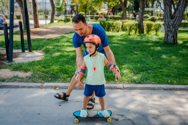 istock Father teaching his son how to skateboard 2168807363