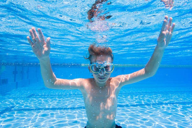 istock Boy Underwater in Swimming Pool 2168807570