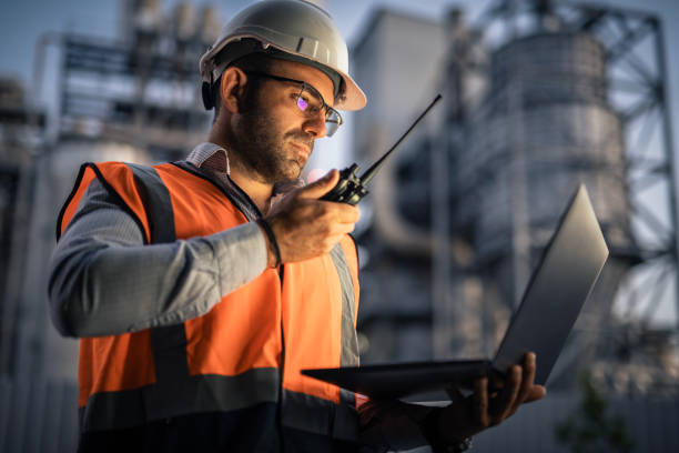 istock Serious handsome engineer using a laptop while working in the oil and gas industry 2168809191