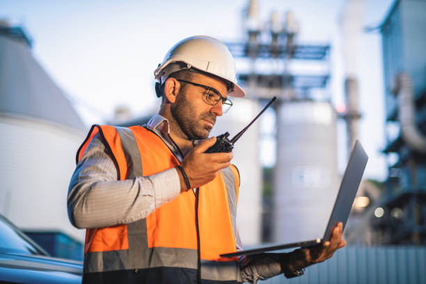 istock Engineer using technology and talking on walkie talkie during working on power line in field. 2168809196
