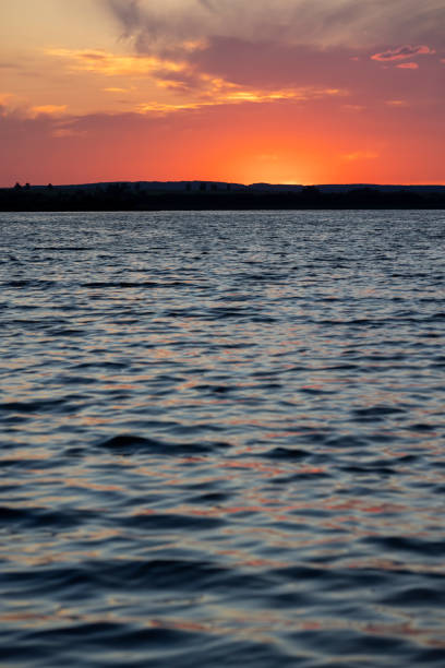 red bright sunset on the lake in the summer, red sky during sunset on the lake shore