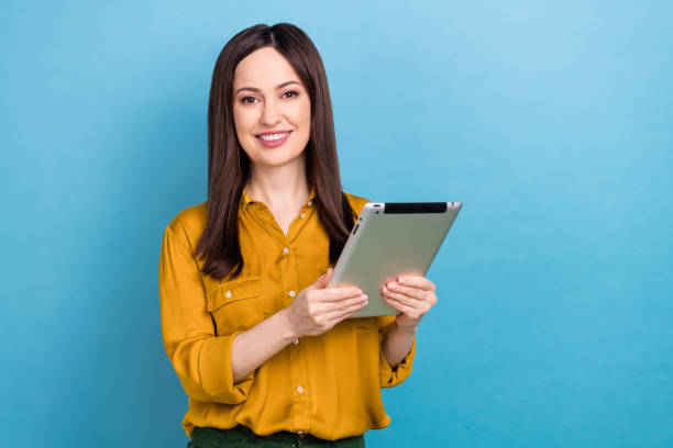 istock Portrait photo of young assistant office worker lady hold electronic tablet browsing analytics information isolated on blue color background 2168810327