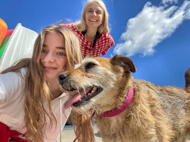 istock Mother and Daughter with their Dog 2168811482
