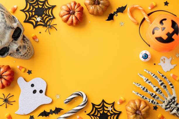 istock Festive Halloween background featuring skulls, pumpkins, candy, and spooky decorations on a bright orange surface 2168811982