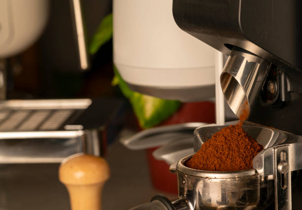 istock Coffee beans in a portafilter by the coffee grinder 2168813334