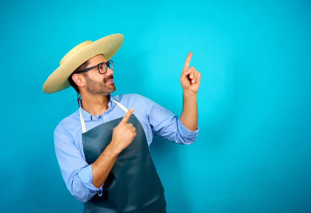 man with traditional hat Chupalla indicating or pointing with finger at copy space, fiestas patrias celebration concept