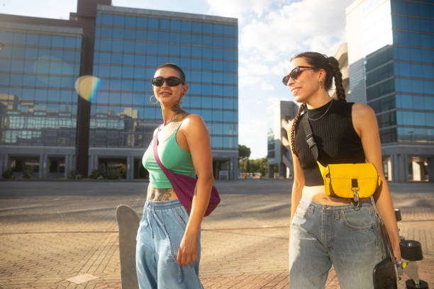 istock Two young woman walking with skateboard 2168820929