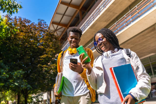 istock African university students using phone outside the university campus 2168821444