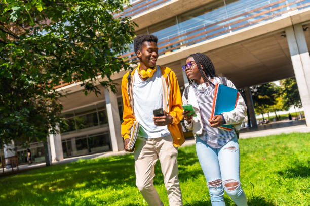 istock African friends using phone walking along university campus 2168821449