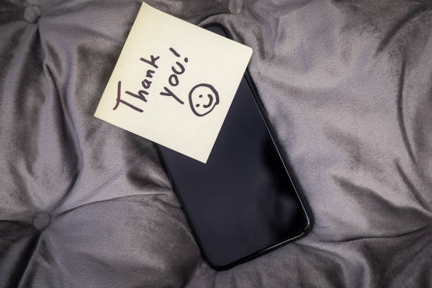 A cell phone with a note on it that says \