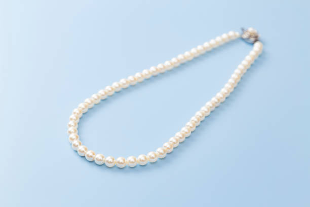 istock Pearl necklace on a blue background 2168824715
