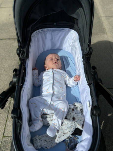 istock A baby boy asleep in their pram 2168828788