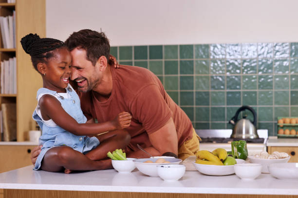 istock Father embracing smiling daughter (6-7) in kitchen 2168833294