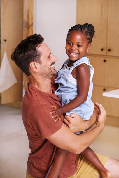 istock Father carrying smiling daughter (6-7) at home 2168833304