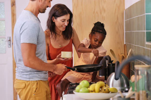 istock Parents with daughter (6-7) coking in kitchen 2168833428
