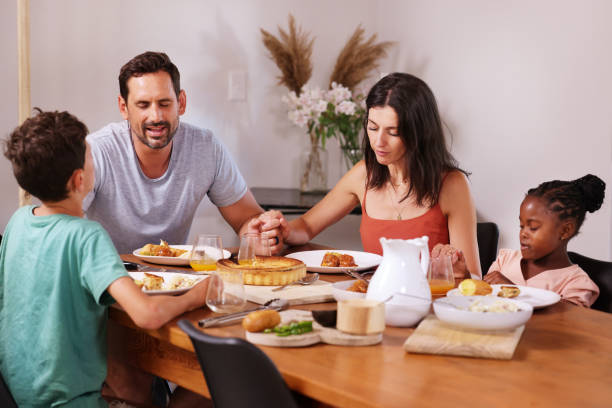 istock Family saying grace at table 2168833453