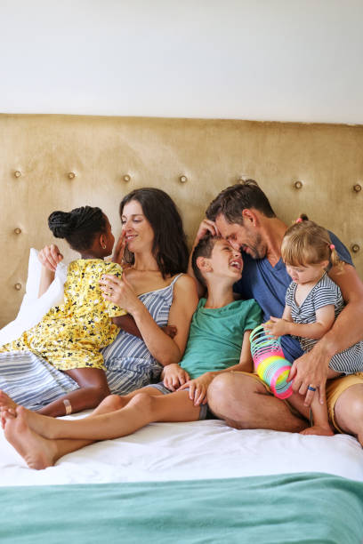 istock Parents with children (18-22 months, 6-7, 8-9) relaxing on bed 2168835952