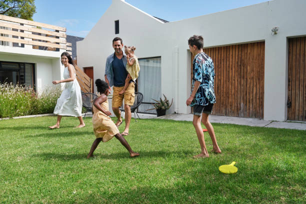 istock Parents with children (18-22 months, 6-7, 8-9) playing on back yard 2168835973