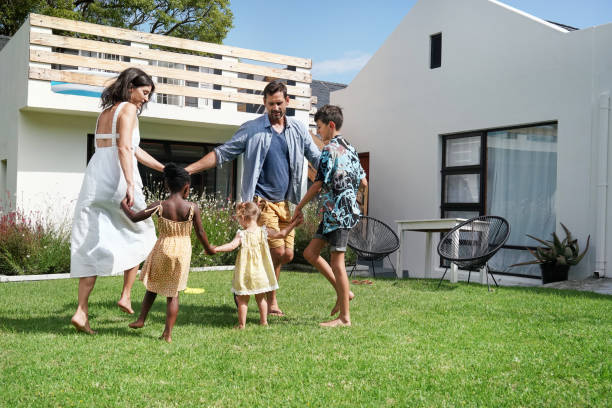 istock Parents with children (18-22 months, 6-7, 8-9) playing on back yard 2168835983