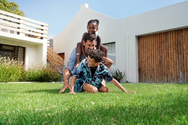 istock Father with children ( 6-7, 8-9) playing on back yard 2168836026